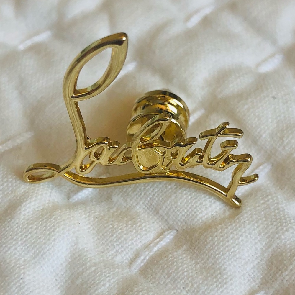 Christian Louboutin pin yellow gold